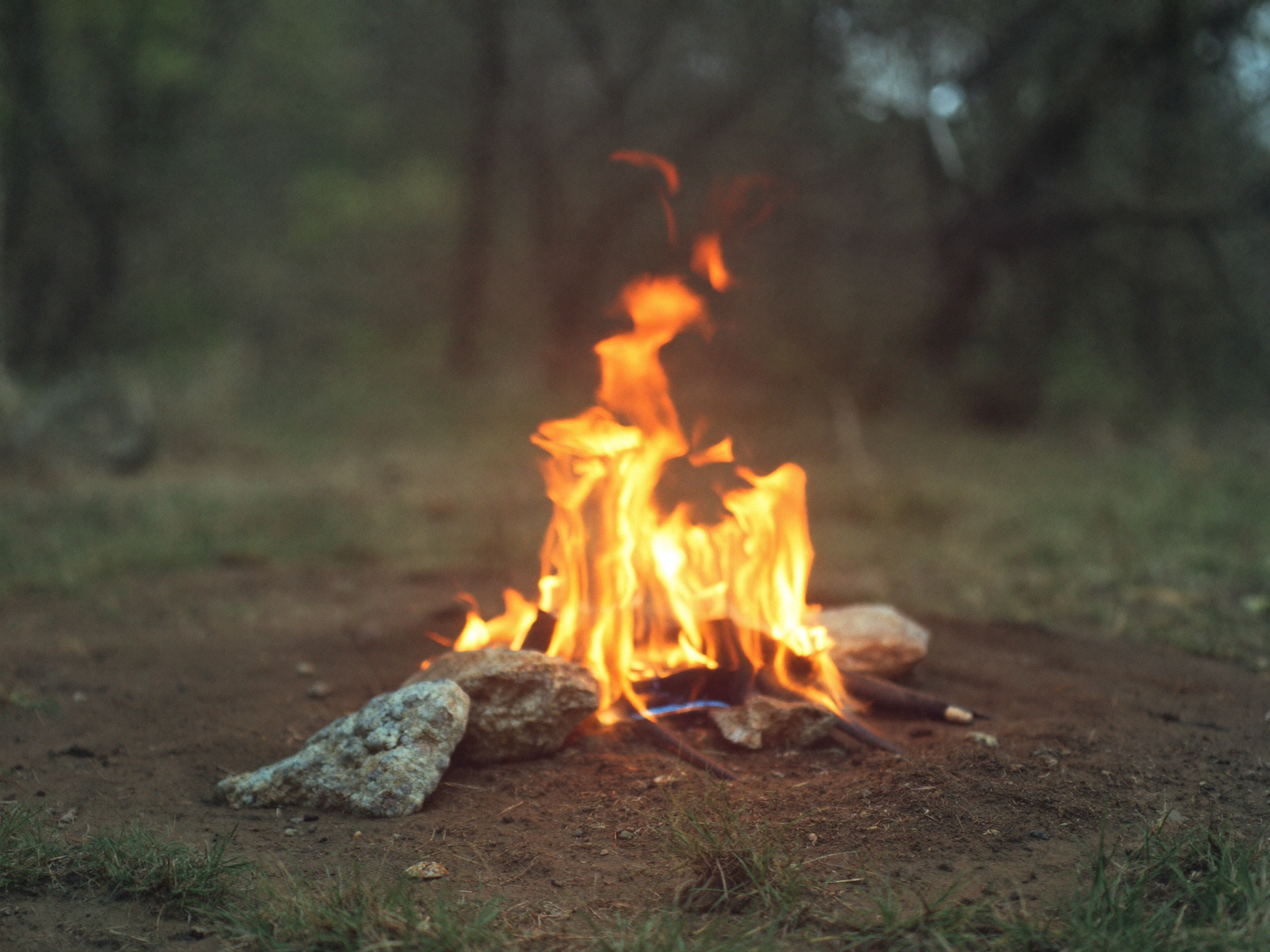 Outdoor fire pit burning in a backyard, the type of contained fire that fire code most often classifies as a portable outdoor fireplace or recreational fire