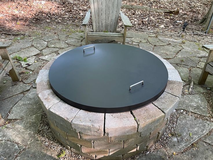 A close-up view of the inner rim of a stainless steel fire pit, showing a series of small, circular air jet holes.