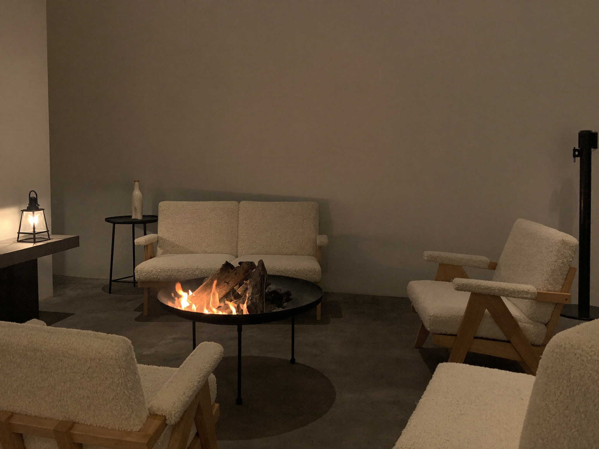 An electric indoor fire pit with a realistic flame effect, positioned as living room furniture with no combustion or fuel involved.