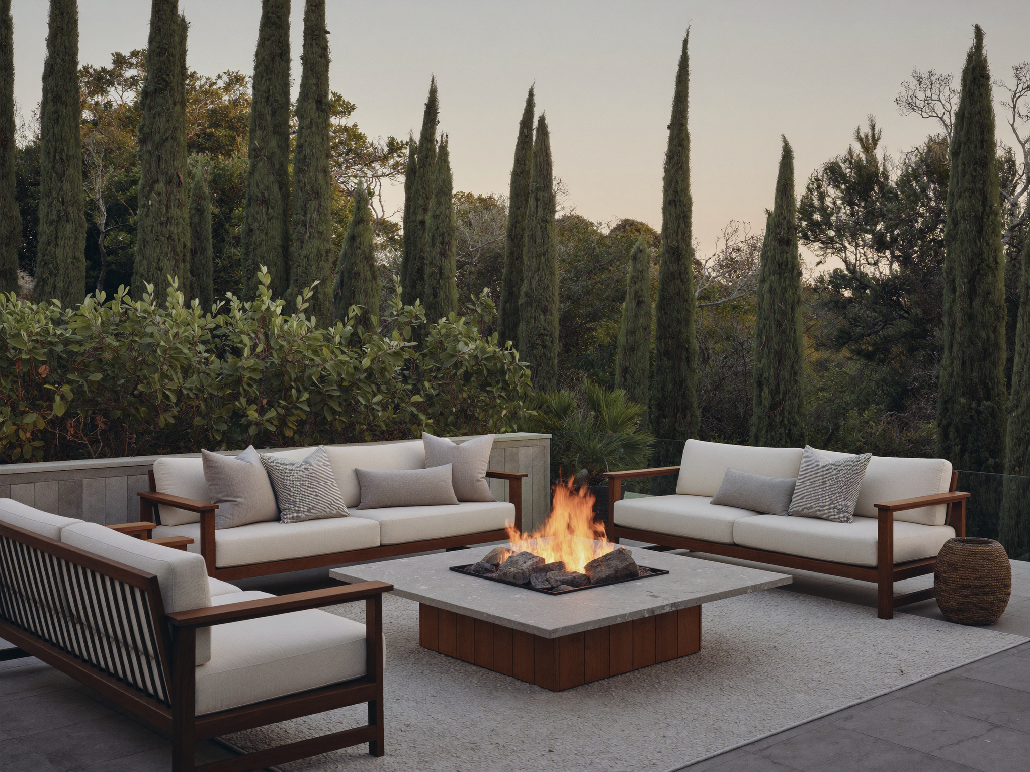 A paver patio built around a fire pit with a stone border