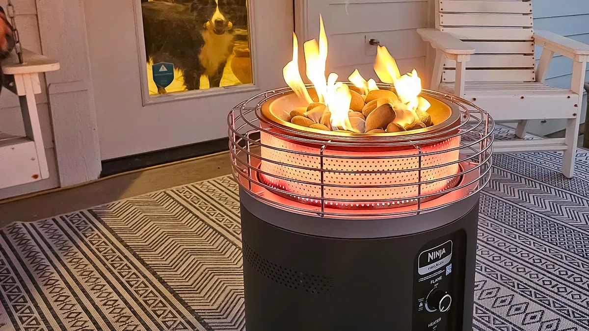 A newly lit double-wall fire pit emitting thick white smoke during the first few minutes before the walls heat up.
