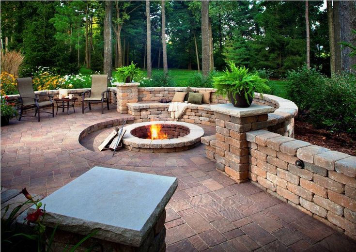 A backyard scene with a line overlay indicating a safe 10-foot clearance zone between a burning metal fire pit and a residential wood siding wall.